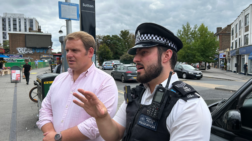 Luke Taylor MP with a police officer outside Sutton Station
